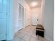 Bright hallway with tiled floors, a bench, and multiple doors at 2302 Silver Palm Dr # 301, Kissimmee, FL 34747