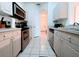 Bright kitchen featuring stainless steel appliances and light cabinets at 2302 Silver Palm Dr # 301, Kissimmee, FL 34747