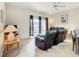 Relaxing living room with leather recliners, a TV, and sliding glass doors leading to the backyard at 702 Calabria Ave, Davenport, FL 33897
