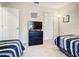 Spacious bedroom with two twin beds, dresser, and TV at 702 Calabria Ave, Davenport, FL 33897