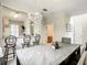Elegant dining room features a stylish chandelier and a view into the kitchen at 702 Calabria Ave, Davenport, FL 33897