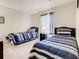 Bright bedroom featuring two twin beds with striped bedding at 702 Calabria Ave, Davenport, FL 33897