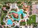 Large community pool with water features and surrounding landscape at 702 Calabria Ave, Davenport, FL 33897