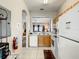Bright kitchen with wood cabinets and white appliances at 702 Calabria Ave, Davenport, FL 33897