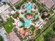 Resort-style pool area with multiple pools, a waterslide, and lounge chairs at 702 Calabria Ave, Davenport, FL 33897