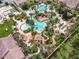 Large resort-style pool complex with multiple pools and a waterslide at 702 Calabria Ave, Davenport, FL 33897