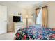 Cozy bedroom with a floral comforter and a flat-screen TV at 702 Calabria Ave, Davenport, FL 33897
