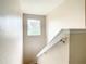 Clean carpeted staircase with a window providing natural light at 702 Calabria Ave, Davenport, FL 33897