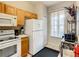 Bright kitchen features white appliances and wood cabinets at 702 Calabria Ave, Davenport, FL 33897