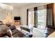 Living room features two leather recliners, a coffee table and access to a patio at 702 Calabria Ave, Davenport, FL 33897