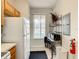 Small galley kitchen with white appliances and wood cabinets at 702 Calabria Ave, Davenport, FL 33897