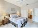Cozy bedroom with a double bed, nightstand, and en-suite bathroom access at 702 Calabria Ave, Davenport, FL 33897