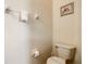 Small half bathroom with toilet and a wall mounted towel rack at 702 Calabria Ave, Davenport, FL 33897