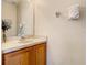 Clean bathroom with wood vanity, sink, and mirror at 702 Calabria Ave, Davenport, FL 33897