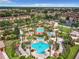 Expansive aerial view of community with large pools and lush landscaping at 702 Calabria Ave, Davenport, FL 33897