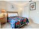 Simple bedroom with double closet and floral bedding at 702 Calabria Ave, Davenport, FL 33897