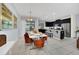 Bright dining area with modern table and chairs, adjacent to a kitchen at 1616 Carey Palm Cir, Kissimmee, FL 34747