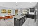 Open kitchen with granite island and dark cabinetry at 1616 Carey Palm Cir, Kissimmee, FL 34747