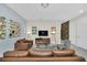 Living room with leather sofas and a modern entertainment center at 1616 Carey Palm Cir, Kissimmee, FL 34747