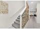 Stylish staircase with modern wall art and carpet at 1616 Carey Palm Cir, Kissimmee, FL 34747