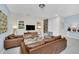 Living room with brown leather couches and a modern coffee table at 1616 Carey Palm Cir, Kissimmee, FL 34747