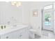 Bright bathroom with white vanity and pool view at 7487 Gathering Dr, Reunion, FL 34747