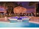 Night view of illuminated pool and spa at 7487 Gathering Dr, Reunion, FL 34747