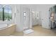 Bathroom with a large soaking tub, shower, and vanity at 7487 Gathering Dr, Reunion, FL 34747