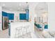 Open concept kitchen with teal cabinets and breakfast bar at 7487 Gathering Dr, Reunion, FL 34747