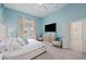 Main bedroom with sliding doors to the outside and a large TV at 7487 Gathering Dr, Reunion, FL 34747