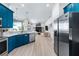Modern kitchen with teal cabinets and stainless steel appliances at 7487 Gathering Dr, Reunion, FL 34747