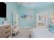 Bright bedroom with ensuite bathroom access and a sitting area at 7487 Gathering Dr, Reunion, FL 34747