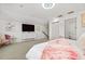 Large bedroom with TV, dresser and en-suite bathroom at 7487 Gathering Dr, Reunion, FL 34747