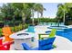 Inviting pool area with colorful chairs and fire pit at 7487 Gathering Dr, Reunion, FL 34747