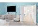 Bedroom with doors leading to another room and a sitting area at 7487 Gathering Dr, Reunion, FL 34747
