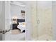 Bathroom with glass shower and view into bedroom at 7487 Gathering Dr, Reunion, FL 34747