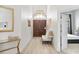 Bright and airy entryway with hardwood floors and seating area at 7487 Gathering Dr, Reunion, FL 34747
