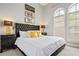 King size bed in a stylish bedroom with gold accents at 7487 Gathering Dr, Reunion, FL 34747