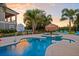 Sunset view of a backyard pool and spa at 7487 Gathering Dr, Reunion, FL 34747