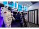 Space-themed bedroom with bunk beds, a ladder, and an astronaut figure at 7487 Gathering Dr, Reunion, FL 34747