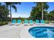 Enjoy this relaxing pool area with lounge chairs at 7487 Gathering Dr, Reunion, FL 34747
