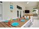 Covered patio with dining table and outdoor kitchen at 7487 Gathering Dr, Reunion, FL 34747