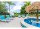 Relaxing pool area with lounge chairs and a tiki umbrella at 7487 Gathering Dr, Reunion, FL 34747