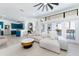 Open living room features a large sectional sofa, coffee table, and pool view at 7487 Gathering Dr, Reunion, FL 34747