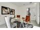 Bright home office features glass desk, leather chairs, and modern artwork at 9217 Hidden Bay Ln, Orlando, FL 32819