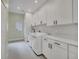 Bright laundry room with white cabinets and quartz countertops at 9217 Hidden Bay Ln, Orlando, FL 32819