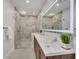 Elegant bathroom with marble finishes and a double vanity at 9217 Hidden Bay Ln, Orlando, FL 32819