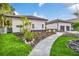 Modern home exterior with a walkway, landscaping, and two-car garage at 9217 Hidden Bay Ln, Orlando, FL 32819
