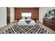 Bedroom with wood accent wall and patterned rug at 9217 Hidden Bay Ln, Orlando, FL 32819