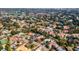 An expansive aerial view showcasing a neighborhood near a golf course and lake at 9217 Hidden Bay Ln, Orlando, FL 32819
